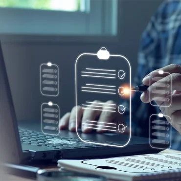 A person using a laptop and a digital checklist overlay to prepare for an ISO surveillance audit in UAE, representing quality management and compliance standards.