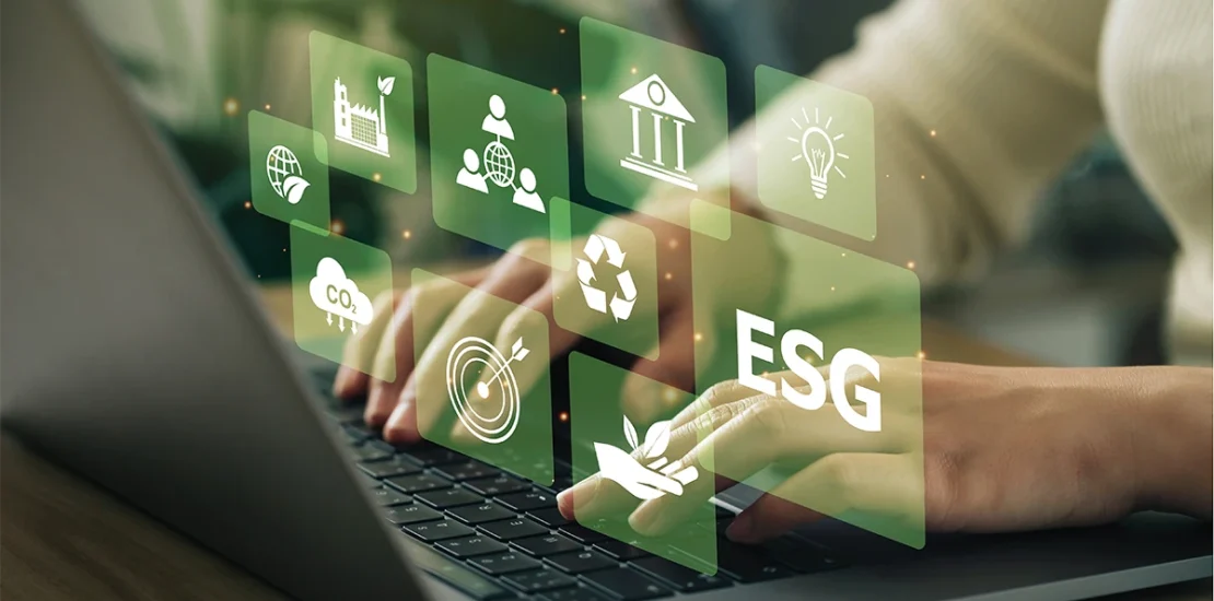 A professional typing on a laptop overlaid with digital icons for sustainability, social responsibility, and governance, representing ESG Reporting in UAE standards.