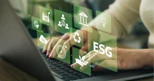 A professional typing on a laptop overlaid with digital icons for sustainability, social responsibility, and governance, representing ESG Reporting in UAE standards.