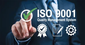 A professional in a suit pointing to a digital ISO 9001 Quality Management System interface with icons for certification, documentation, and processes, representing the transition to the ISO 9001:2026 Revision.