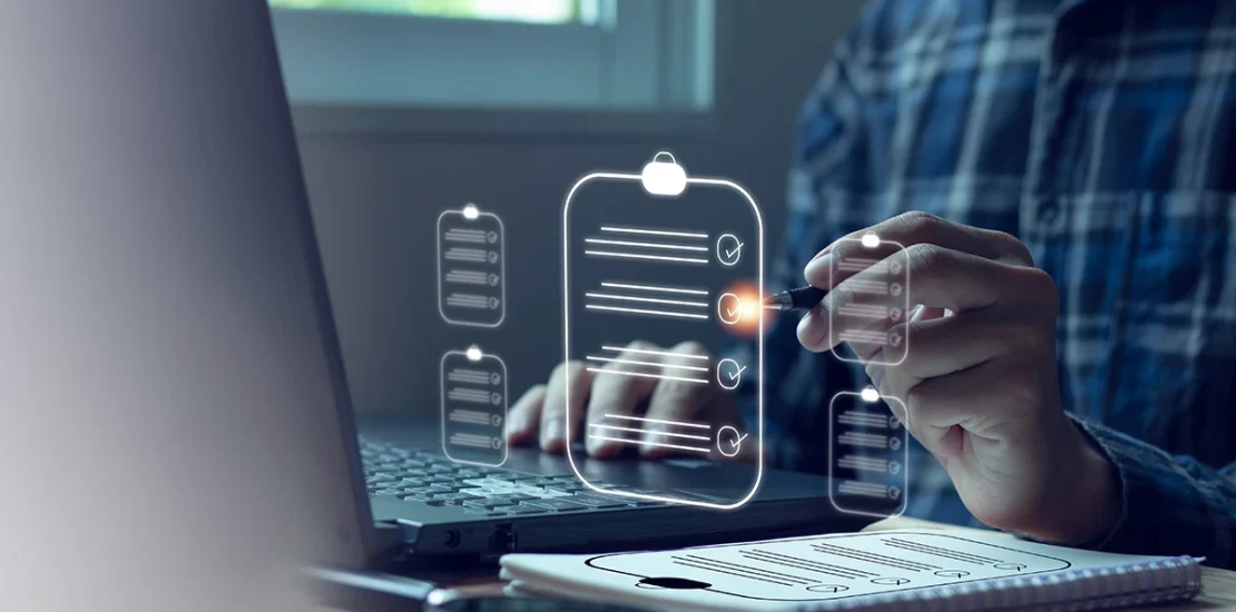 A person using a laptop and a digital checklist overlay to prepare for an ISO surveillance audit in UAE, representing quality management and compliance standards.