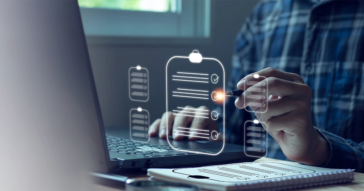 A person using a laptop and a digital checklist overlay to prepare for an ISO surveillance audit in UAE, representing quality management and compliance standards.